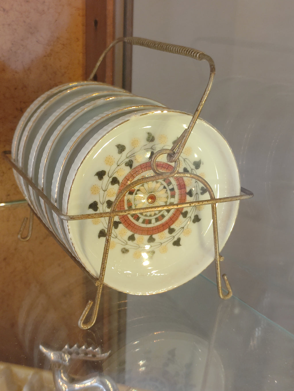 antique porcelain coasters in carry cage